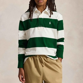 Model wearing Ralph Lauren Iconic Pony Logo Striped Rugby Shirt in cream and green bold stripes, long sleeves, with khaki trousers.
