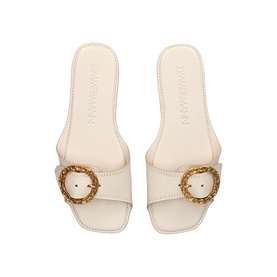 Zimmermann white leather slide sandals with round woven gold-tone buckle detail, square open toe, flat sole, top-down view.