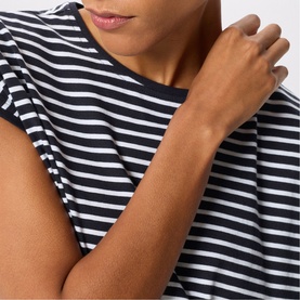 Model wearing Whistles blue and white stripe short sleeve top, close-up detail shot showing neckline and sleeve