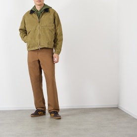 Model wearing Vans brown cotton casual jacket with green collar detail, styled with tan trousers and brown trainers