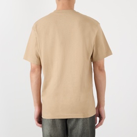 Model wearing Vans beige cotton T-shirt, back view, styled with grey distressed jeans.