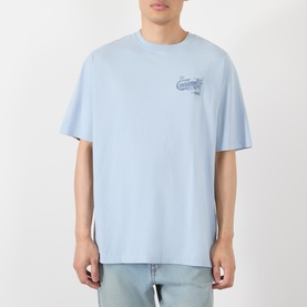 Model wearing Vans light blue cotton T-shirt with small chest graphic print, styled with light wash jeans