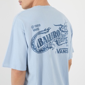 Model wearing Vans light blue cotton T-shirt, rear view showing dragon and Ballero graphic print with 1989 branding.