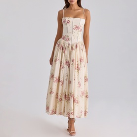 Model wearing House of CB Ivory Vintage Rose floral midi dress with corseted bodice, thin straps, and full pleated skirt.