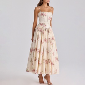 Model wearing House of CB Ivory Vintage Rose floral midi dress with corseted bodice, thin straps, and full pleated skirt, styled with strappy heels.