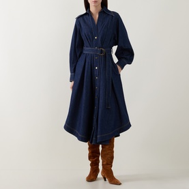Model wearing Zimmermann Belted Denim Shirt Dress in Harbour Blue with D-ring belt, flared midi skirt, styled with tan knee-high boots