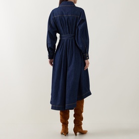 Model wearing Zimmermann Belted Denim Shirt Dress in Harbour Blue, showing back view with flared midi skirt and topstitching, styled with tan