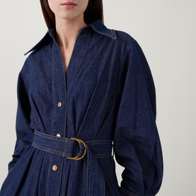 Model wearing Zimmermann Belted Denim Shirt Dress in Harbour Blue, featuring V-neckline, classic collar, and D-ring gold-tone waist belt.