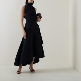 Model wearing Zimmermann Night Sky dress in navy cotton, styled with burgundy clutch bag and brown heeled sandals