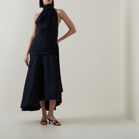Model wearing Zimmermann Night Sky cotton halterneck midi dress with asymmetric hem, styled with red strappy heeled sandals
