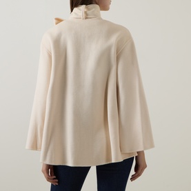 Model wearing Zimmermann cream wool-blend cape jacket with wide sleeves, ruffled high neck and flared silhouette, rear view