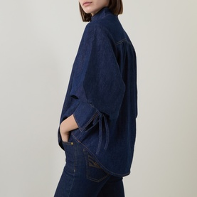 Model wearing Zimmermann harbour blue denim shirt, relaxed fit with kimono-style sleeves, styled with matching dark denim jeans