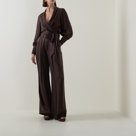 Model wearing Zimmermann Bitter Chocolate silk top with wide-leg trousers and brown platform sandals