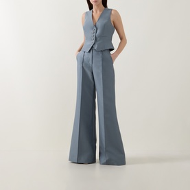 Model wearing Zimmermann Valiant Single-Breasted Waistcoat in Airforce, styled with matching wide-leg trousers in pinstripe fabric.
