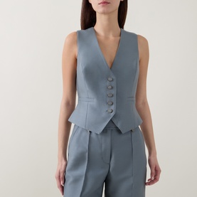 Model wearing Zimmermann Valiant Single-Breasted Waistcoat in Airforce, deep V-neck, front buttons, cropped hem. Styled with matching wide-leg