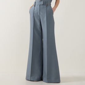 Model wearing Zimmermann Valiant Structured Flared Leg Trousers in Airforce, wide-leg silhouette with pintuck detail and belt loops visible