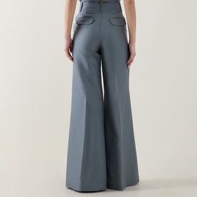 Model wearing Zimmermann Valiant Structured Flared Leg Trousers in Airforce, rear view showing back flap pockets and wide flared leg silhouette.