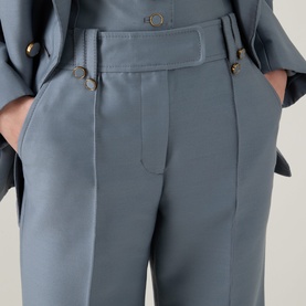Model wearing Zimmermann Valiant Structured Flared Leg Trousers in Airforce, mid-rise with belt loops, hook-bar fastening and pintuck detailing