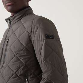 Model wearing Bugatti Air Series Diamond Quilted Jacket in olive, showing diamond quilted texture, stand-up collar, and logo badge on sleeve.