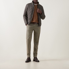 Model wearing Bugatti Air Series Diamond Quilted Jacket in olive with stand-up collar, styled with brown knitwear, khaki trousers and dark leather