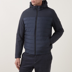 Model wearing Bugatti Quilted Hooded Jacket in blue with horizontal quilted bodice, toggle hood, and sleeve logo patch, styled with dark trousers