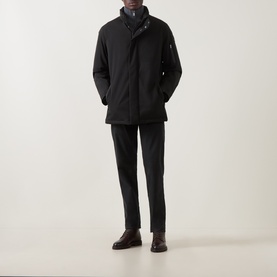 Model wearing Bugatti Rain Series Parka Jacket in black with stand collar and concealed zip placket, styled with dark trousers and brown leather