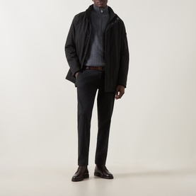 Model wearing Bugatti Rain Series Parka Jacket in black with stand collar, styled with grey ribbed knitwear, dark trousers and brown leather shoes.