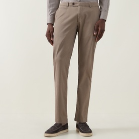 Model wearing Bugatti Micro Flex Slim-Leg Chinos in beige, slim fit with clean hems, styled with grey shirt and dark loafers.