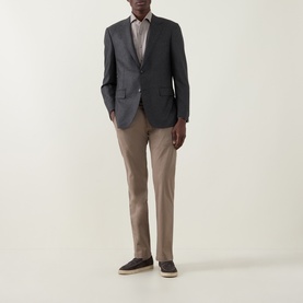 Model wearing Bugatti Micro Flex Slim-Leg Chinos in beige, styled with a grey blazer and dark loafers.
