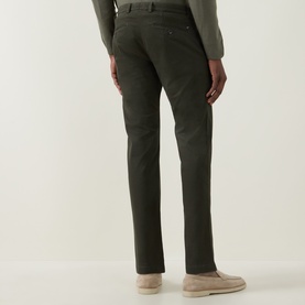 Model wearing Bugatti Micro Flex Slim-Leg Chinos in green, slim fit with clean hems, styled with a grey knit and beige loafers
