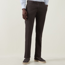 Model wearing Bugatti Micro Flex Slim-Leg Chinos in brown, styled with a light blue shirt and grey loafers