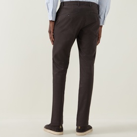 Model wearing Bugatti Micro Flex Slim-Leg Chinos in brown, rear view showing slim fit, belt loops and rear welt pockets, styled with loafers.