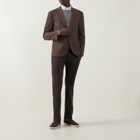Model wearing Bugatti Micro Flex Slim-Leg Chinos in brown, styled with a matching blazer, grey top and dark canvas shoes.