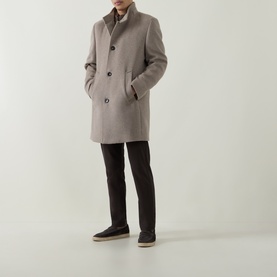 Model wearing Bugatti beige wool-blend coat with funnel neck, button front, and side pockets, styled with dark trousers and navy shoes.