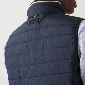 Model wearing Bugatti Air Series Padded Gilet in navy, rear view showing quilted design, funnel neckline with contrast trim and logo detail.