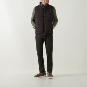 Model wearing Bugatti brown quilted polyester gilet, styled with olive green long-sleeve top and matching trousers