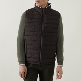Model wearing Bugatti brown quilted gilet with zip fastening, styled with olive green sweatshirt and dark trousers.