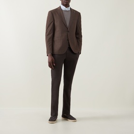 Model wearing Bugatti Birdseye Single-Breasted Blazer in brown with notch lapel, styled with dark trousers and grey crew-neck jumper.