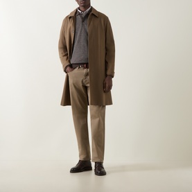 Model wearing Bugatti brown sweat layered under a tan overcoat, styled with beige trousers and dark leather shoes.