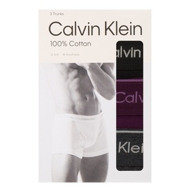 Calvin Klein Three-Pack Classic Logo Trunks in black, dark purple and charcoal heather, shown in retail packaging with model detail