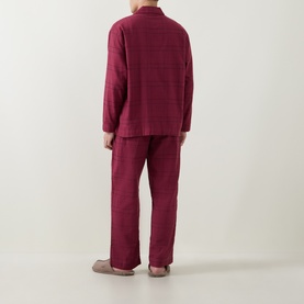 Model wearing Calvin Klein Flannel Check Print Pyjama Set in Established Red, back view, paired with grey slippers.
