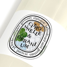 Diptyque Citronnelle & Geranium candle, close-up of oval label on white glass vessel with botanical illustration detail