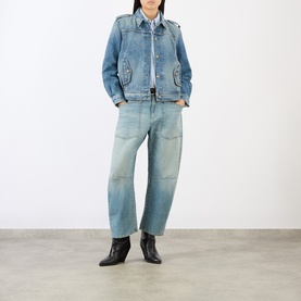 Model wearing Nili Lotan Rosebowl Wash denim jacket with barrel-leg jeans and black ankle boots.