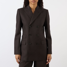 Model wearing Nili Lotan brown herringbone double-breasted blazer jacket with flap pockets, styled with matching trousers.