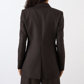 Model wearing Nili Lotan brown herringbone blazer jacket, shown from the back, with a tailored single-vent silhouette.