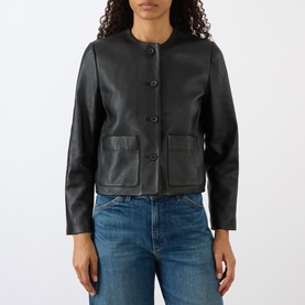 Model wearing Nili Lotan Ophelie Cropped Leather Jacket in black, collarless with front buttons and patch pockets, styled with blue jeans