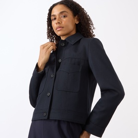 Model wearing Nili Lotan midnight jacket with patch pockets and button front, styled with matching trousers