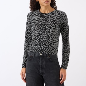 Model wearing Nili Lotan knitwear in Pebble Grey Heather/Black Cheetah print, styled with dark grey jeans.