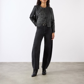 Model wearing Nili Lotan Pebble Grey Heather/Black Cheetah knitwear, styled with black leather jacket, wide-leg dark jeans and black ankle boots.