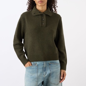 Model wearing Nili Lotan Renata Turtleneck Sweater in Dark Pine Melange with half placket, styled with light blue jeans.